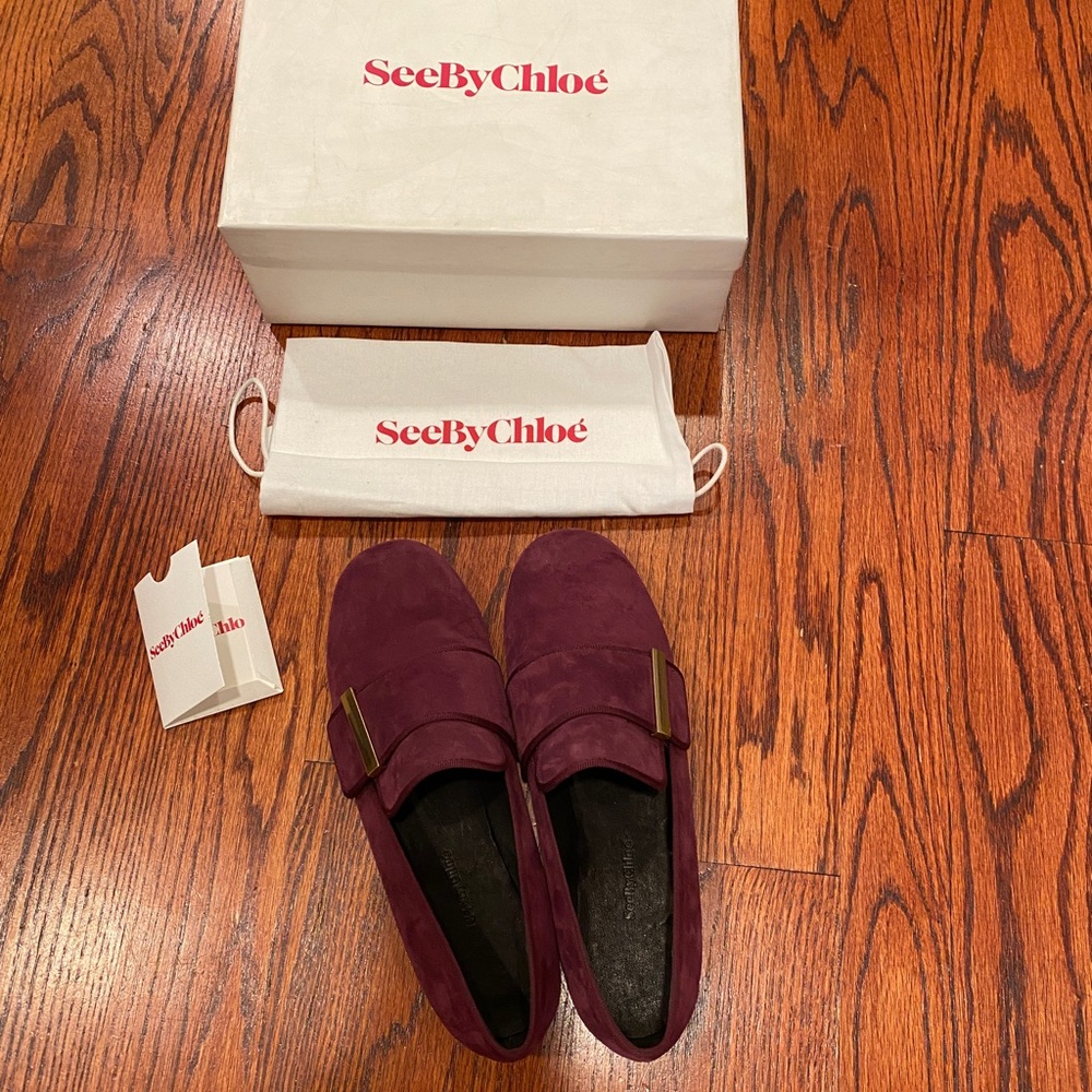 See By Chloe NIB red suede loafers with sleek buckle ornament.